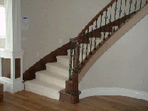Cherry Circular staircase with Classic newels & Basket Iron Balusters
